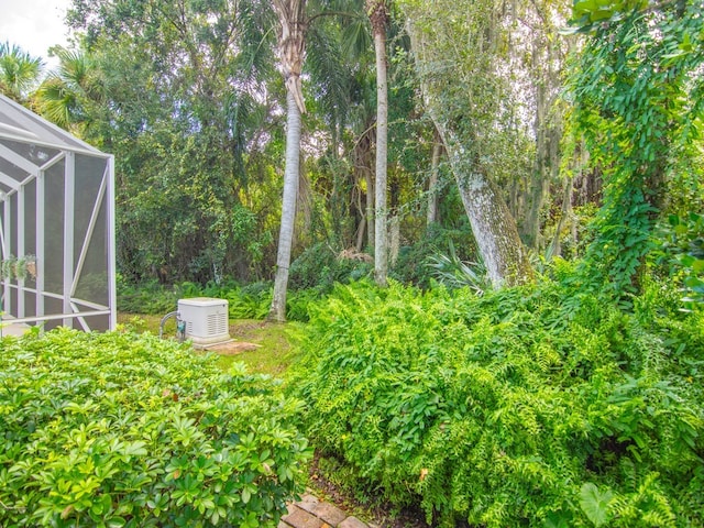 view of yard featuring glass enclosure