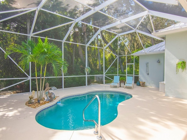 view of swimming pool featuring a patio and a lanai