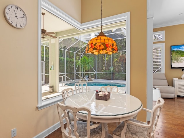 dining area featuring ceiling fan, hardwood / wood-style flooring, and ornamental molding