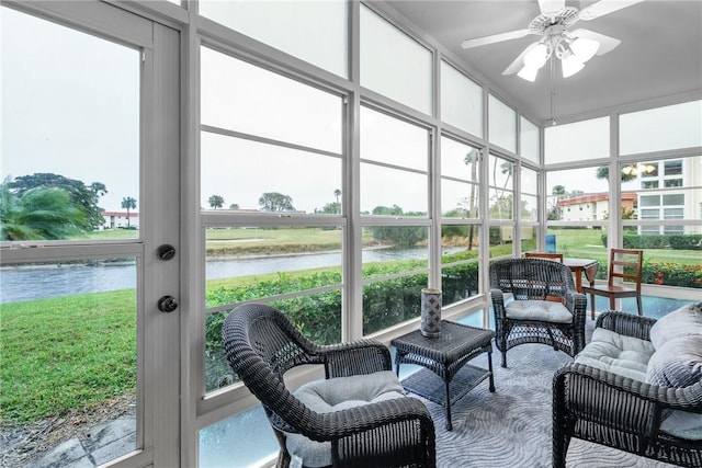 sunroom with a water view and ceiling fan