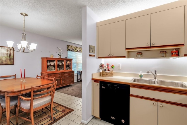 kitchen featuring hanging light fixtures, light tile patterned floors, a textured ceiling, black dishwasher, and cream cabinetry