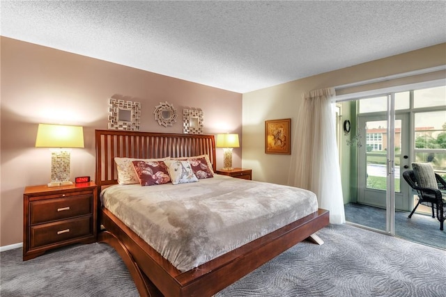 carpeted bedroom featuring french doors, a textured ceiling, and access to outside