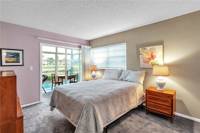 bedroom featuring carpet floors and a textured ceiling