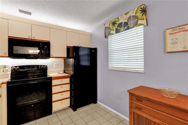 kitchen featuring white cabinetry, light tile patterned floors, a textured ceiling, and black appliances