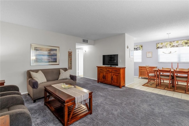 living room featuring light colored carpet and a textured ceiling