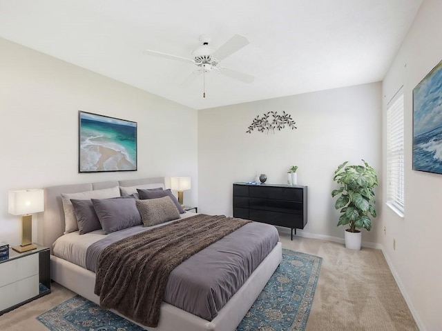 bedroom with ceiling fan and light carpet