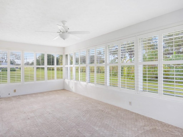 unfurnished sunroom with ceiling fan and a wealth of natural light