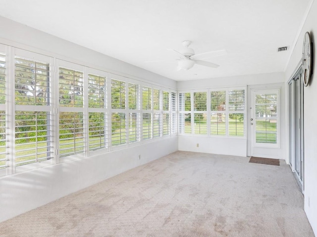 unfurnished sunroom with ceiling fan