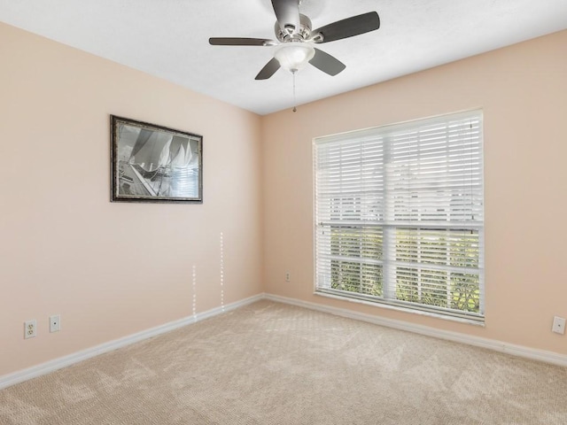 unfurnished room featuring light colored carpet and ceiling fan