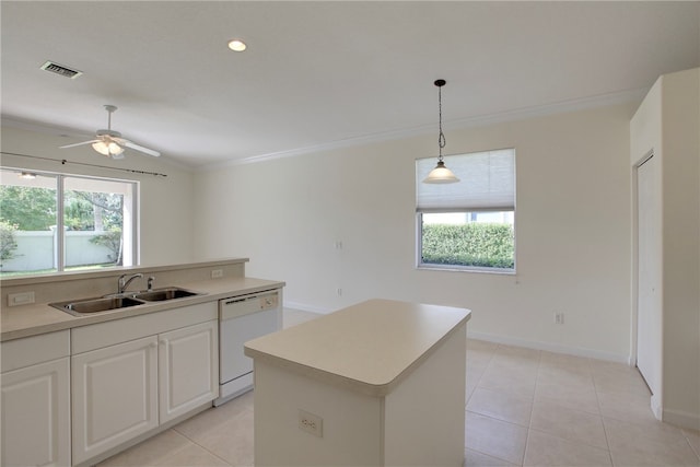 kitchen featuring white cabinetry, sink, white dishwasher, a healthy amount of sunlight, and a kitchen island