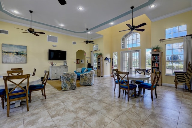 dining area featuring a high ceiling, french doors, and ornamental molding