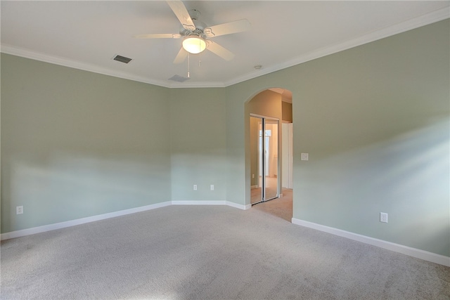 unfurnished room featuring light carpet, crown molding, and ceiling fan