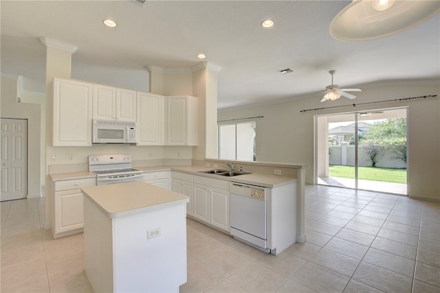 kitchen featuring white cabinetry, sink, white appliances, and light tile patterned floors