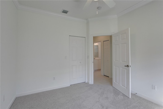 spare room featuring light colored carpet, ceiling fan, and crown molding