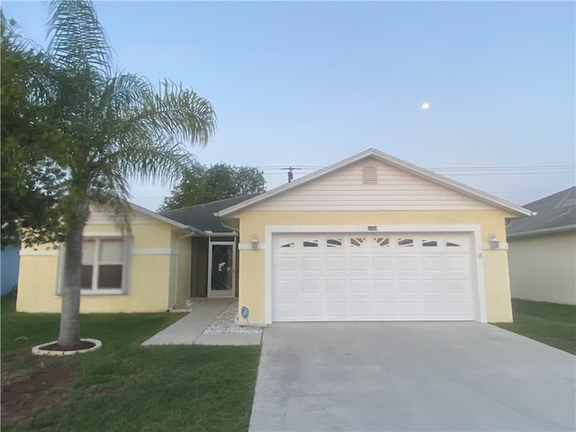 ranch-style home with a garage and a front yard