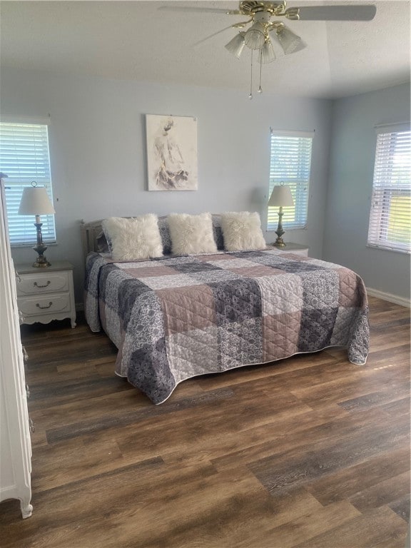 bedroom with ceiling fan and dark hardwood / wood-style flooring