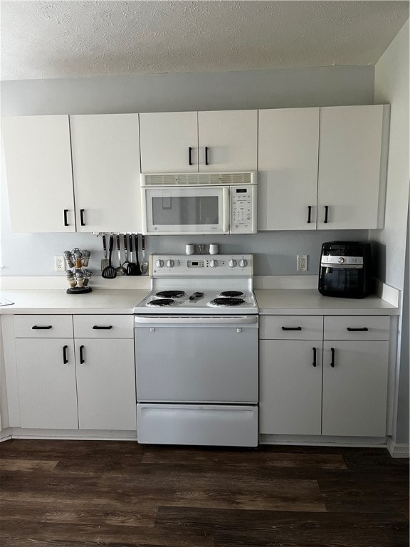 kitchen featuring dark wood-type flooring, white appliances, a textured ceiling, and white cabinets