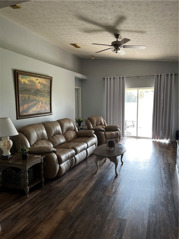 living room with dark hardwood / wood-style flooring, a textured ceiling, and ceiling fan