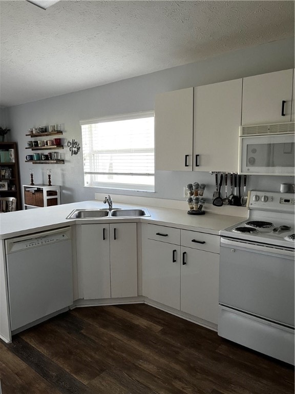 kitchen with white cabinetry, white appliances, a textured ceiling, and dark hardwood / wood-style floors