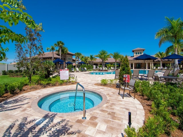 view of swimming pool with a patio and a community hot tub