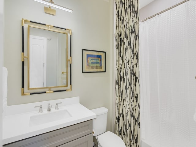 bathroom featuring vanity, toilet, and a shower with curtain