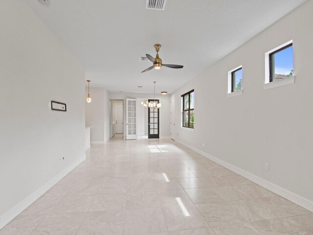 kitchen featuring stainless steel appliances, kitchen peninsula, sink, pendant lighting, and white cabinetry