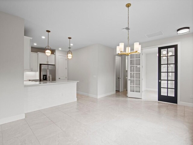 washroom with cabinets, washing machine and dryer, sink, and light tile patterned floors