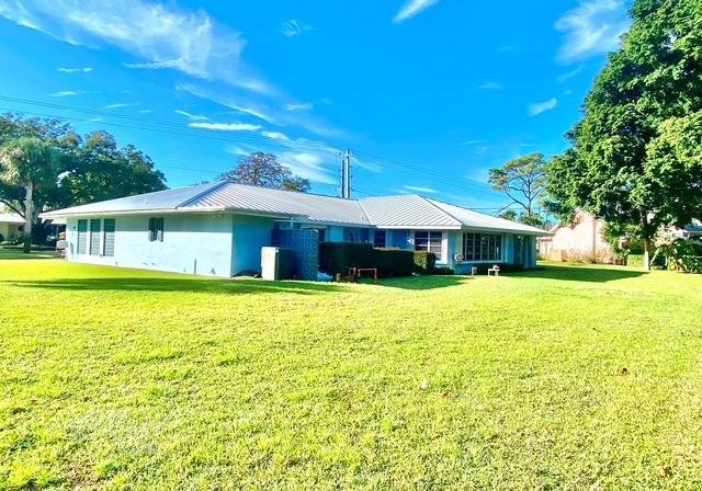 rear view of house with a lawn