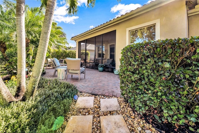 view of patio with a sunroom