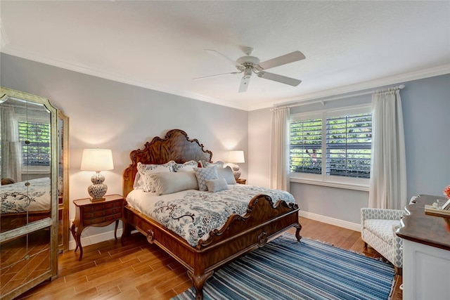 bedroom featuring light hardwood / wood-style flooring, ceiling fan, and ornamental molding