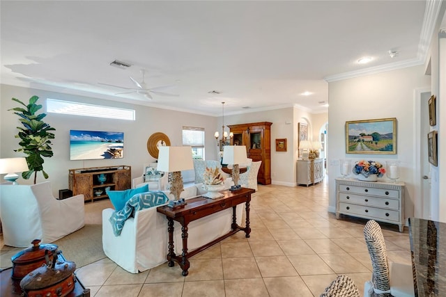 tiled living room featuring crown molding and ceiling fan with notable chandelier