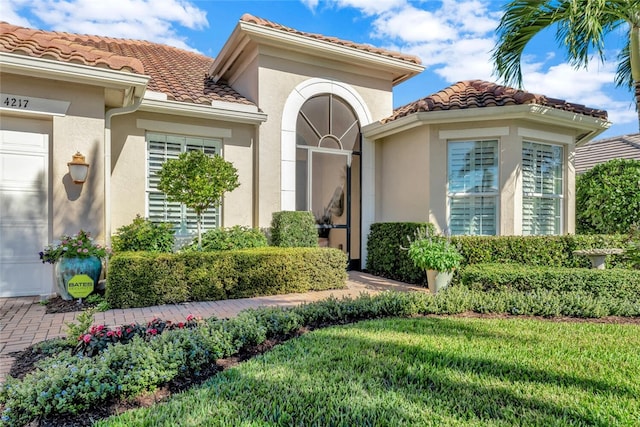 doorway to property featuring a yard