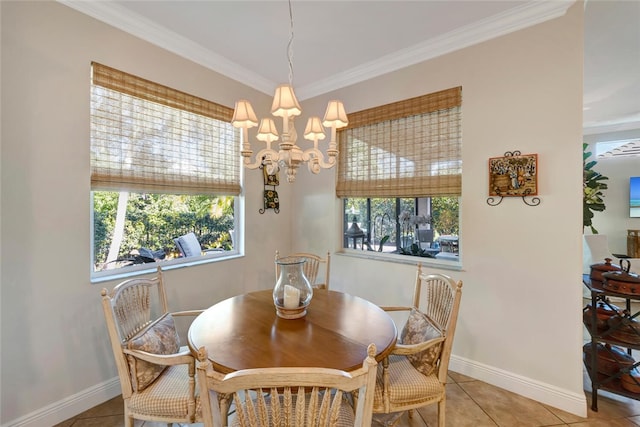 dining room with tile patterned floors, ornamental molding, and an inviting chandelier