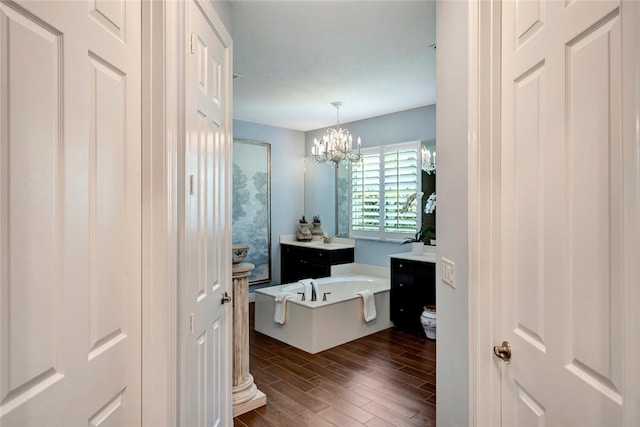 bathroom featuring a bathtub, vanity, and a chandelier