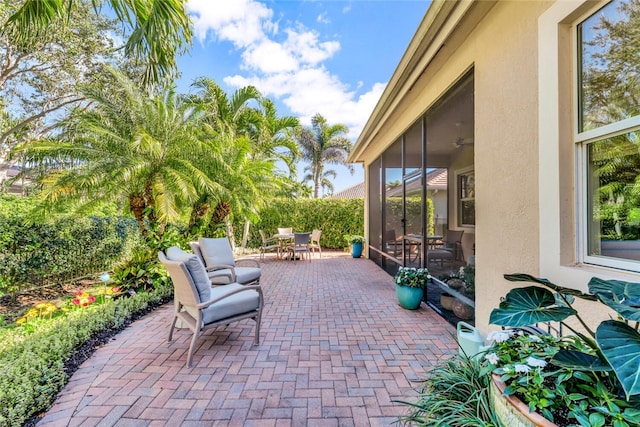 view of patio / terrace featuring a sunroom