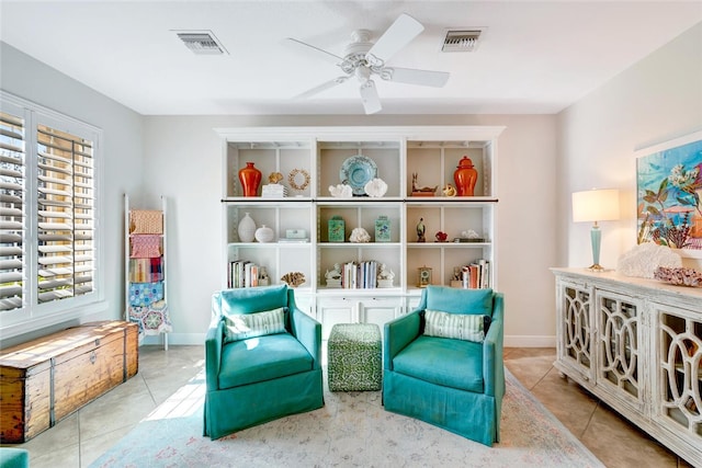 sitting room featuring ceiling fan and light tile patterned floors