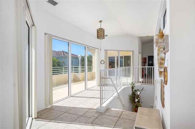 interior space with light tile patterned floors and lofted ceiling