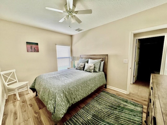 bedroom with hardwood / wood-style flooring and ceiling fan