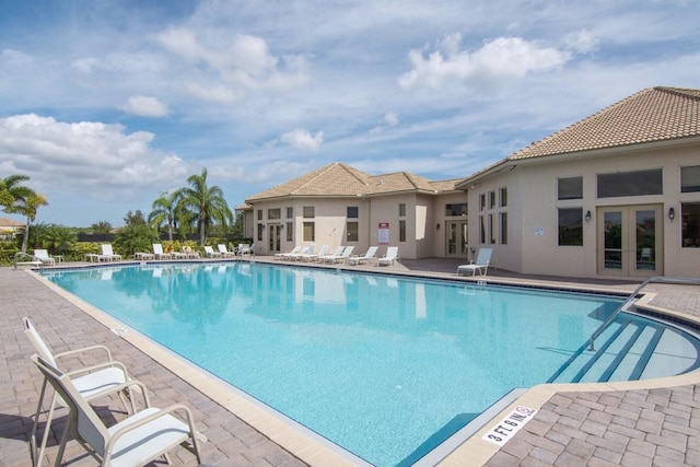 view of pool featuring french doors and a patio