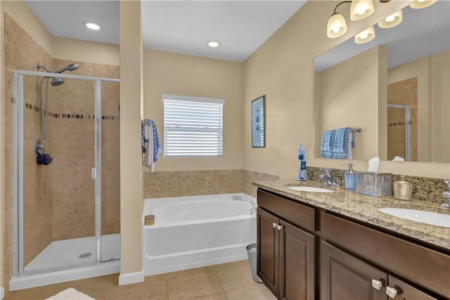 bathroom featuring tile patterned floors, vanity, and plus walk in shower