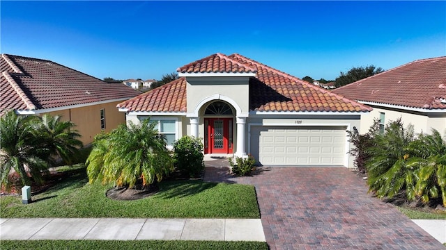 mediterranean / spanish-style home with a garage