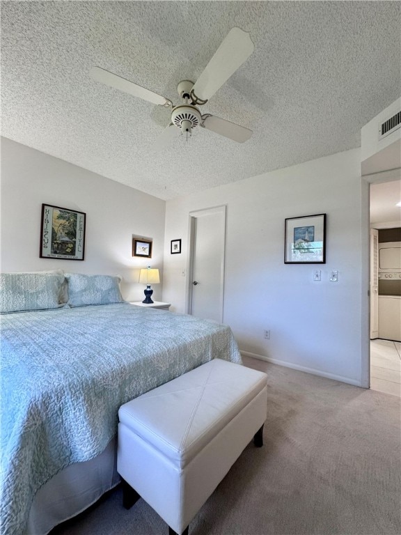 bedroom with carpet flooring, ceiling fan, and a textured ceiling