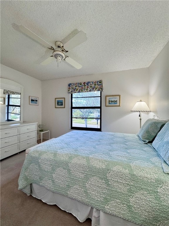 bedroom with carpet, ceiling fan, and a textured ceiling