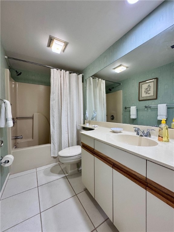 full bathroom featuring tile patterned flooring, vanity, toilet, and shower / bath combo