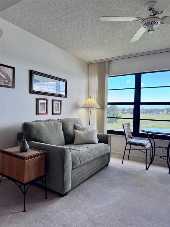 carpeted living room with a textured ceiling and ceiling fan