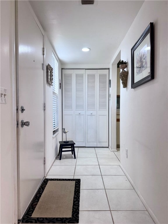 hallway with light tile patterned floors