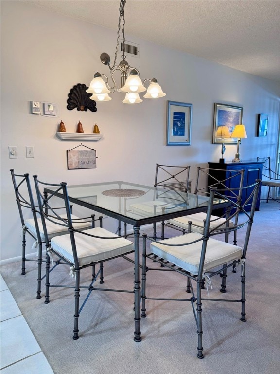 dining room featuring a textured ceiling and an inviting chandelier