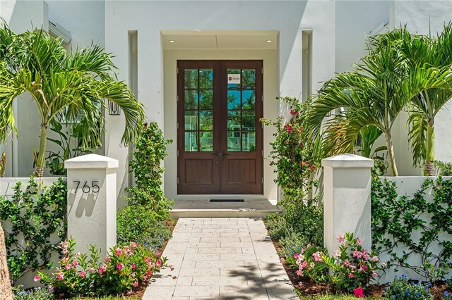 765 Azalea Ln, Vero Beach, FL 32963 - doorway to property with french doors and stucco siding