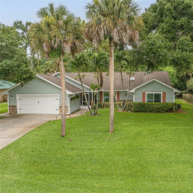 ranch-style home featuring a garage and a front lawn