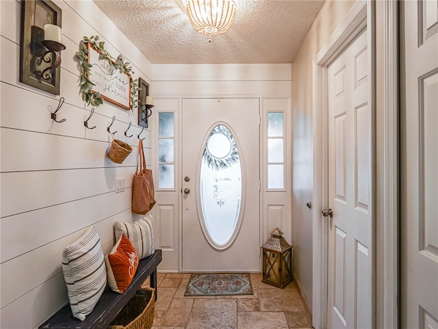 entryway with a textured ceiling